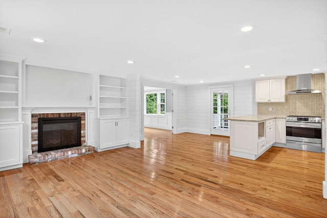 28 Stoney Cliff Rd, Centerville, MA 02632 - unfurnished living room with light wood-style flooring, a fireplace, recessed lighting, and built in shelves