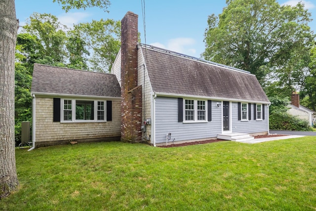 28 Stoney Cliff Rd, Centerville, MA 02632 - dutch colonial featuring a chimney, roof with shingles, and a front lawn