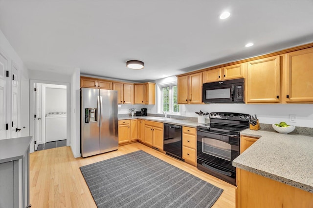13 Pickerel Way, Forestdale, MA 02644 - kitchen with black appliances, washer / dryer, a sink, light wood-style flooring, and recessed lighting