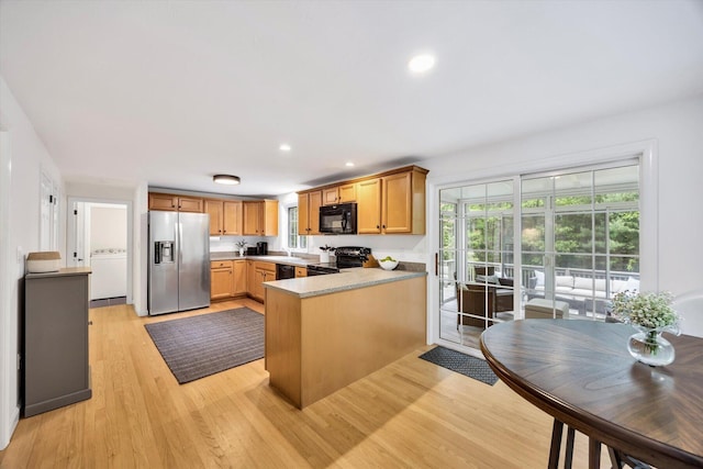 13 Pickerel Way, Forestdale, MA 02644 - kitchen with black appliances, a peninsula, light wood-style flooring, washer / clothes dryer, and recessed lighting