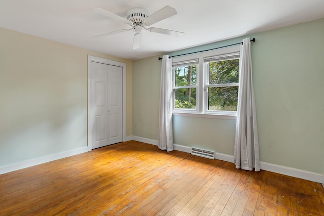 empty room with light wood-type flooring and ceiling fan