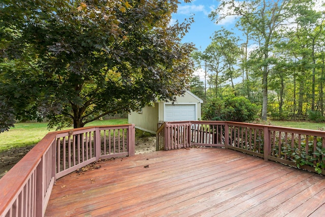 wooden deck with a garage and an outbuilding