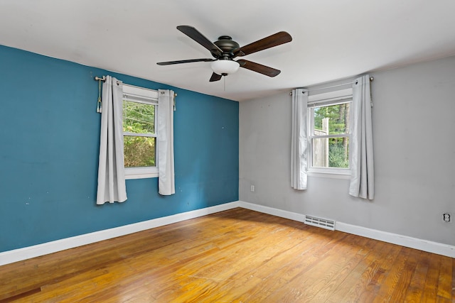 empty room featuring wood-type flooring and ceiling fan