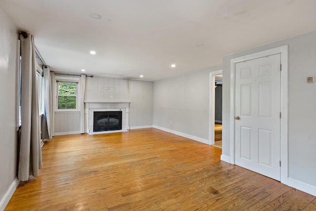 unfurnished living room with light hardwood / wood-style floors and a fireplace