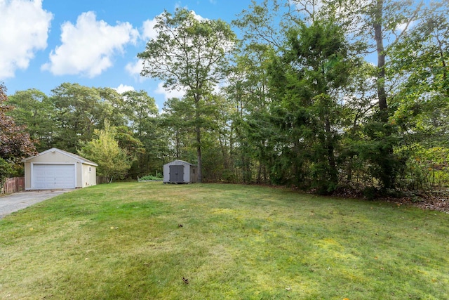 view of yard with a garage and a shed