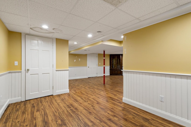 spare room with hardwood / wood-style flooring and a paneled ceiling