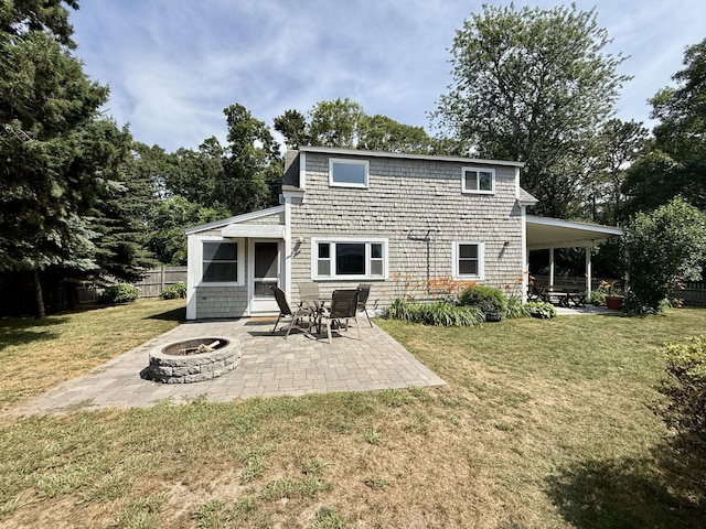 9 Kens Way W, Yarmouth, MA 02673 - back of property with an outdoor fire pit and a patio area