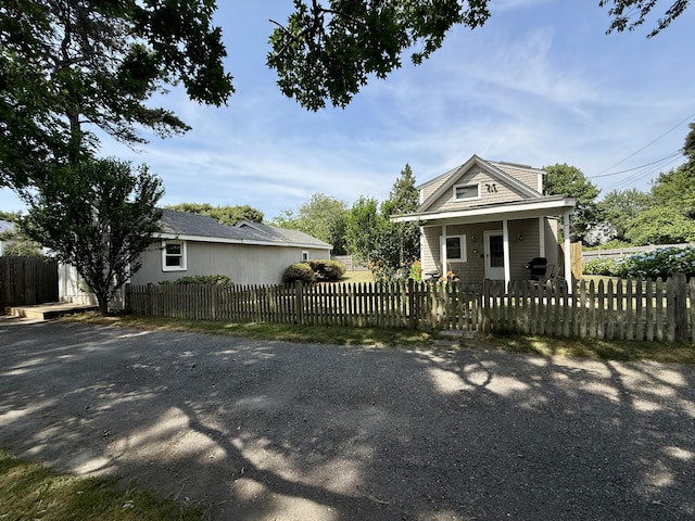 9 Kens Way W, Yarmouth, MA 02673 - view of front of home featuring a porch and a fenced front yard