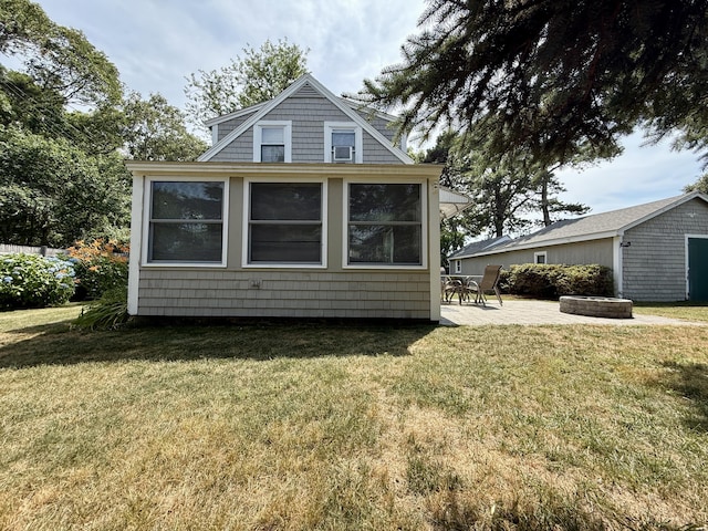 9 Kens Way W, Yarmouth, MA 02673 - view of property exterior with a lawn, an outbuilding, and a patio area