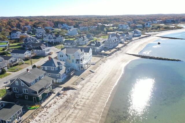 birds eye view of property with a water view and a view of the beach