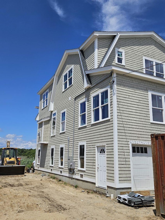 rear view of property with a garage