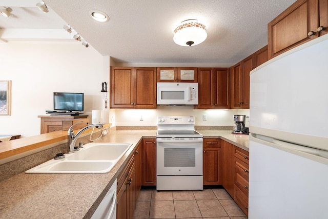 248 Kates Path, Yarmouth Port, MA 02675 - kitchen with white appliances, brown cabinetry, light countertops, light tile patterned flooring, and glass insert cabinets