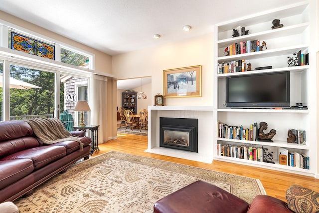 248 Kates Path, Yarmouth Port, MA 02675 - living area with wood finished floors and a fireplace with flush hearth