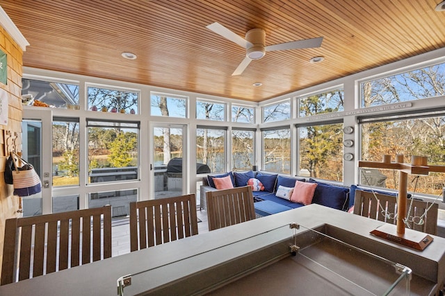 sunroom featuring ceiling fan, wooden ceiling, and a healthy amount of sunlight