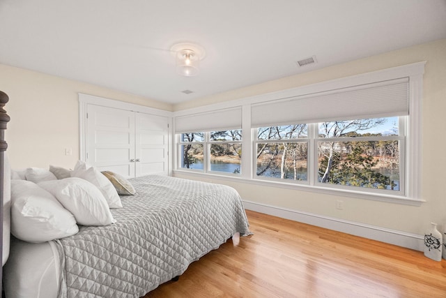 bedroom with hardwood / wood-style flooring and a closet