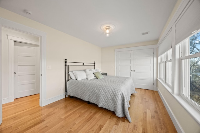 bedroom featuring light hardwood / wood-style floors and a closet