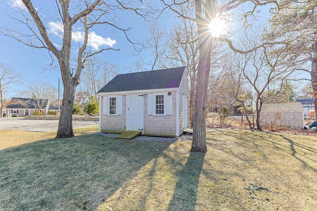 view of outdoor structure with a lawn