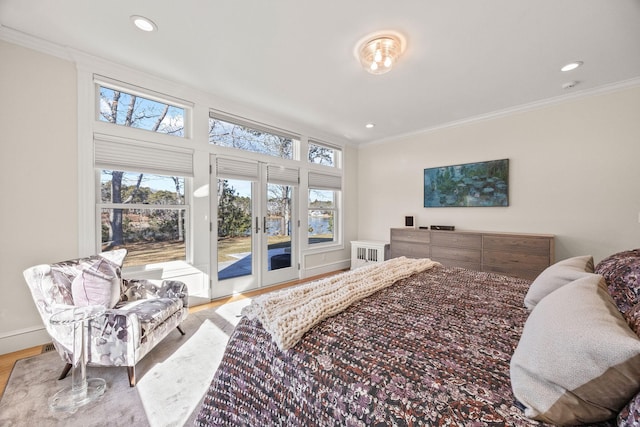 bedroom featuring french doors, ornamental molding, light hardwood / wood-style floors, and access to outside