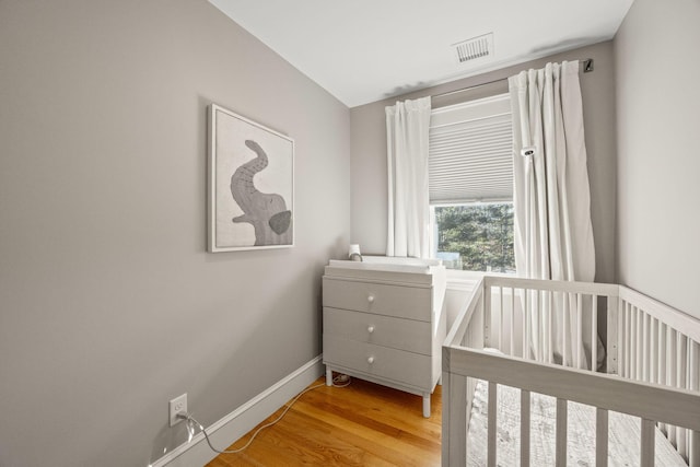 20 Chase St, West Harwich, MA 02671 - bedroom with baseboards, wood finished floors, and a crib