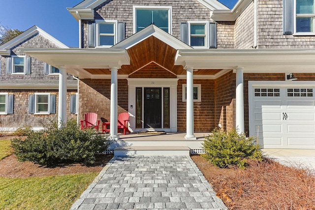 doorway to property featuring a garage and covered porch