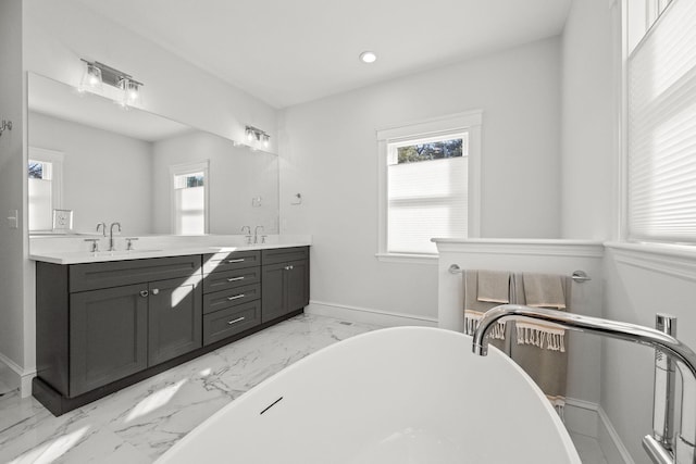 bathroom with vanity and a bath