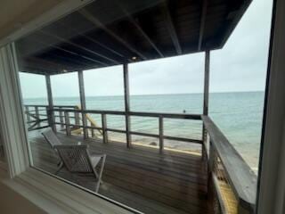 dock area with a view of the beach and a water view