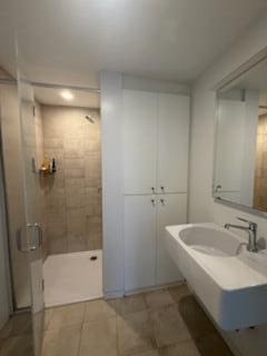 full bathroom with tile patterned floors and a shower stall