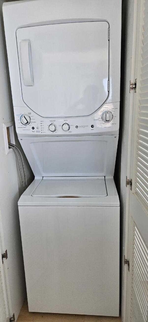 laundry room featuring laundry area and stacked washer and clothes dryer