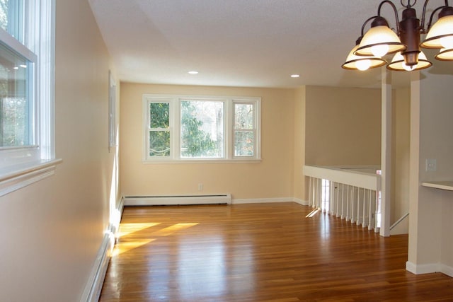 103 Braeside Rd, West Falmouth, MA 02540 - unfurnished room with wood finished floors, baseboards, baseboard heating, recessed lighting, and a notable chandelier