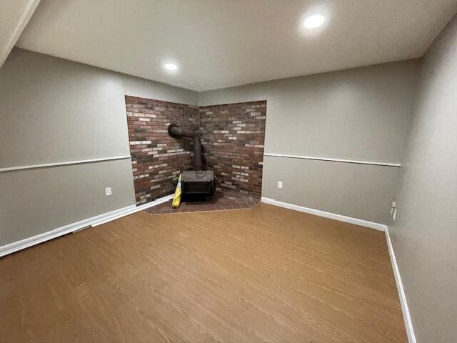 103 Braeside Rd, West Falmouth, MA 02540 - finished basement featuring recessed lighting, baseboards, wood finished floors, and a wood stove