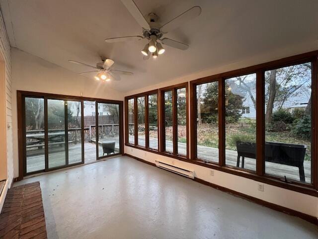 unfurnished sunroom featuring a ceiling fan, a baseboard radiator, and vaulted ceiling