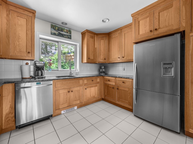 50 View Crest Dr, Falmouth, MA 02540 - kitchen featuring stainless steel appliances, tasteful backsplash, dark stone countertops, brown cabinets, and light tile patterned flooring