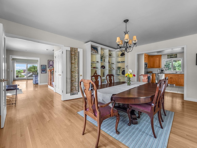 50 View Crest Dr, Falmouth, MA 02540 - dining area featuring a chandelier, light wood-type flooring, and healthy amount of natural light