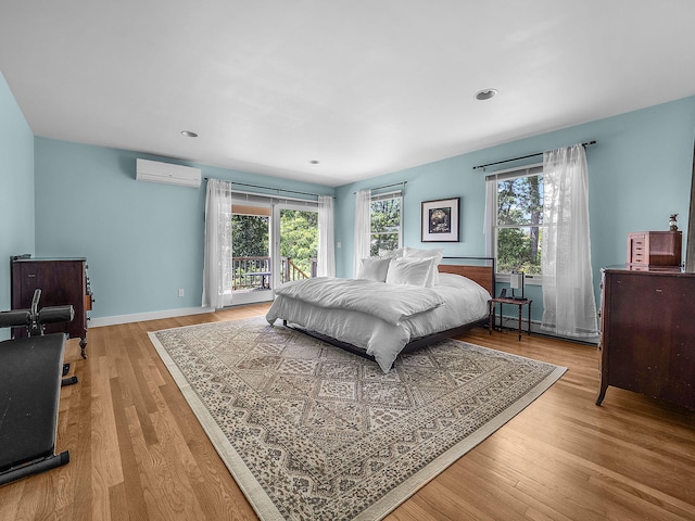 50 View Crest Dr, Falmouth, MA 02540 - bedroom with a wall unit AC, multiple windows, wood finished floors, a baseboard radiator, and recessed lighting