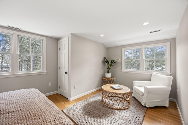 bedroom with light hardwood / wood-style floors and lofted ceiling