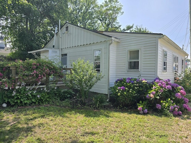 230 Old Wharf Rd Unit 274, Dennis Port, MA 02639 - view of side of home featuring a lawn and board and batten siding