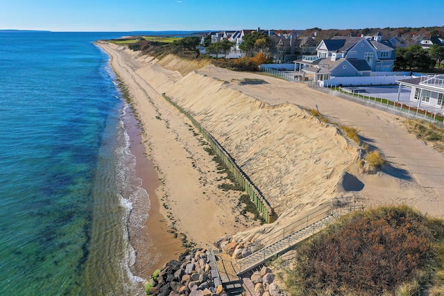 aerial view with a water view and a beach view