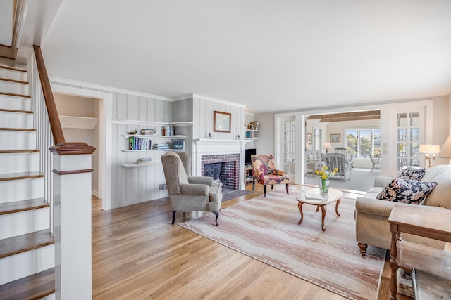 14 Trinity Cv, West Harwich, MA 02671 - living area with wood finished floors, stairs, and a brick fireplace