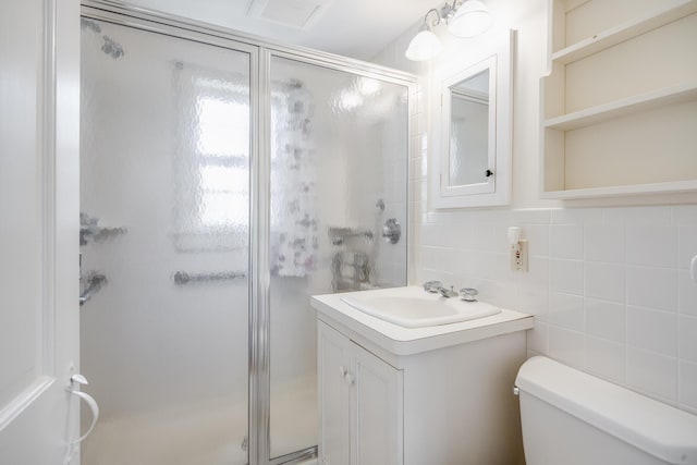 bathroom with visible vents, toilet, a stall shower, and vanity