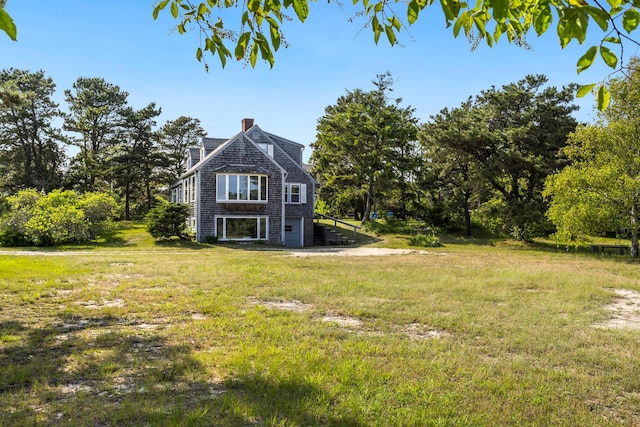 14 Trinity Cv, West Harwich, MA 02671 - view of property exterior with a lawn and a chimney