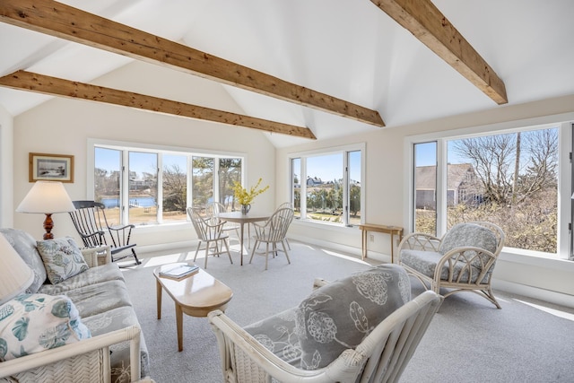 carpeted living room featuring baseboards and vaulted ceiling with beams