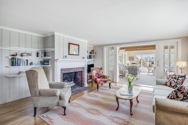 14 Trinity Cv, West Harwich, MA 02671 - living room with wood finished floors, a brick fireplace, and crown molding