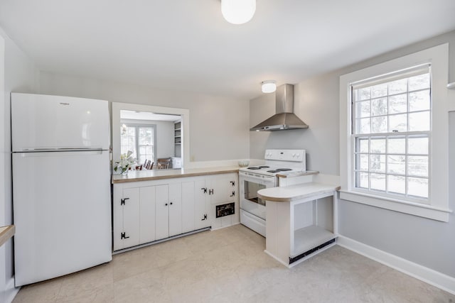 14 Trinity Cv, West Harwich, MA 02671 - kitchen featuring white appliances, wall chimney exhaust hood, light countertops, and white cabinets