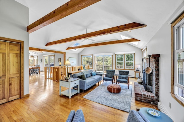 3 Amber Way, Truro, MA 02666 - living area featuring beam ceiling, light wood-type flooring, a fireplace, a ceiling fan, and high vaulted ceiling