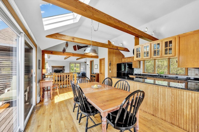 3 Amber Way, Truro, MA 02666 - dining room with a skylight, light wood-style floors, and a fireplace