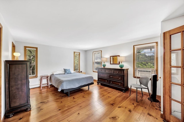 3 Amber Way, Truro, MA 02666 - bedroom with multiple windows, a baseboard radiator, light wood finished floors, and cooling unit