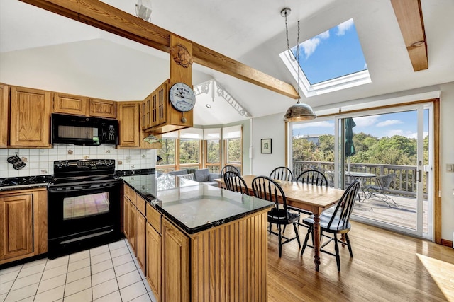 3 Amber Way, Truro, MA 02666 - kitchen with black appliances, a skylight, a peninsula, brown cabinets, and beamed ceiling