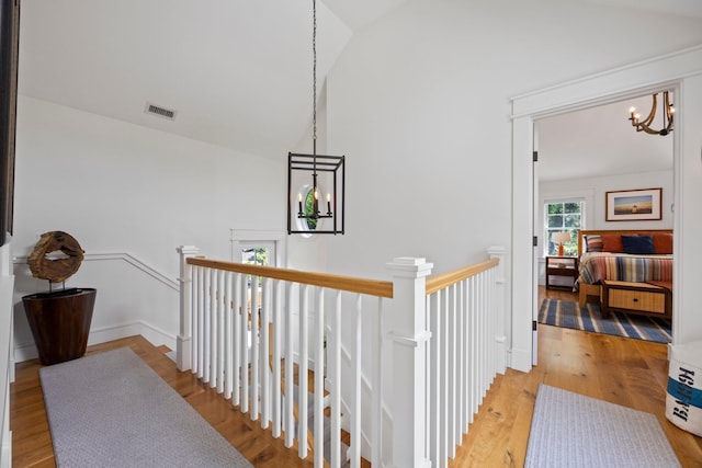 29 Point St, Provincetown, MA 02657 - corridor featuring a chandelier, an upstairs landing, lofted ceiling, and wood finished floors