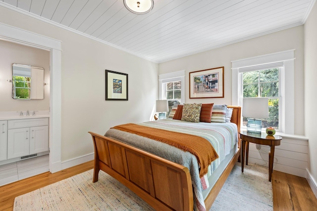 29 Point St, Provincetown, MA 02657 - bedroom with light wood-style floors, a sink, crown molding, baseboards, and wood ceiling