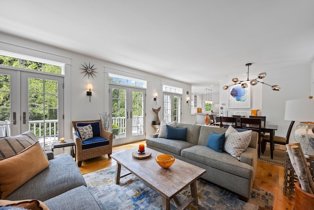 29 Point St, Provincetown, MA 02657 - living area featuring french doors, wood finished floors, and a chandelier